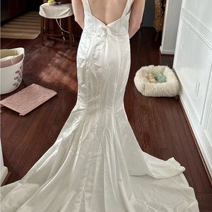 White satin wedding gown with straps and bow on back